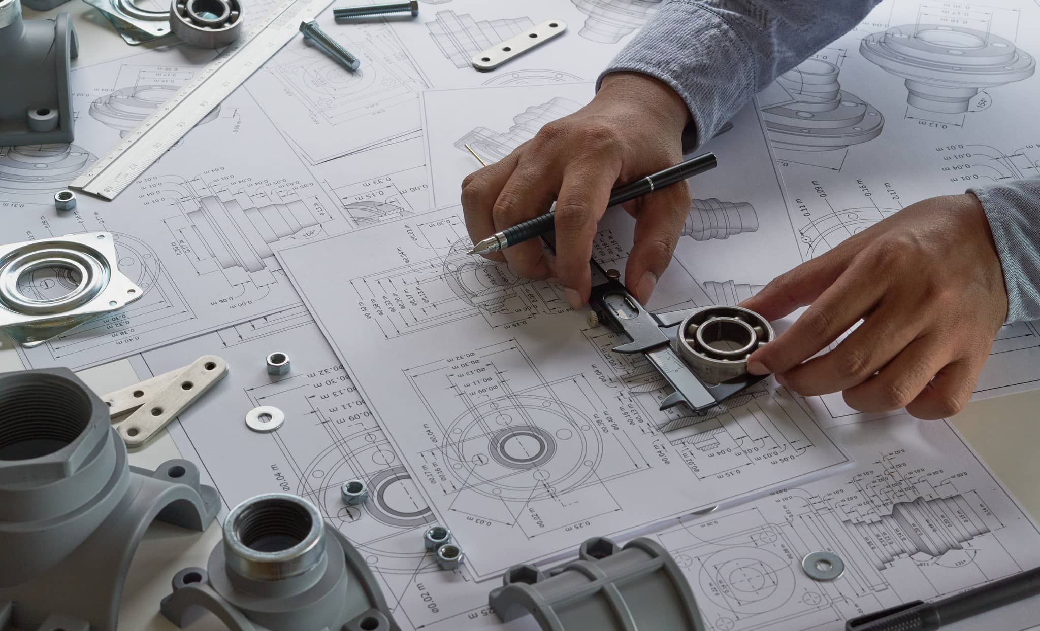 A person using measuring instruments on a design