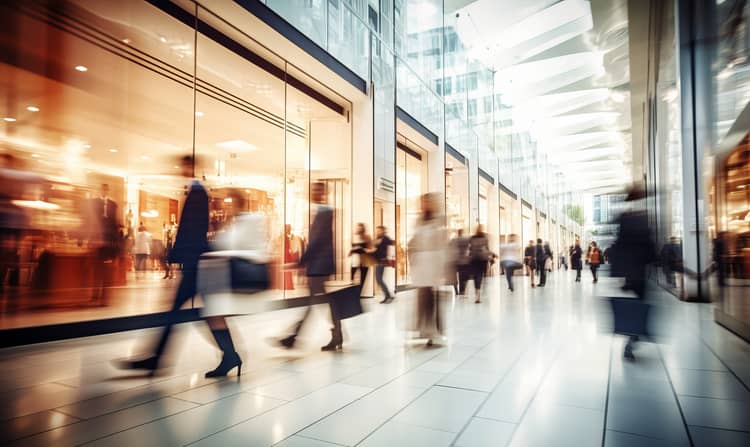 A shopping mall with people walking in it