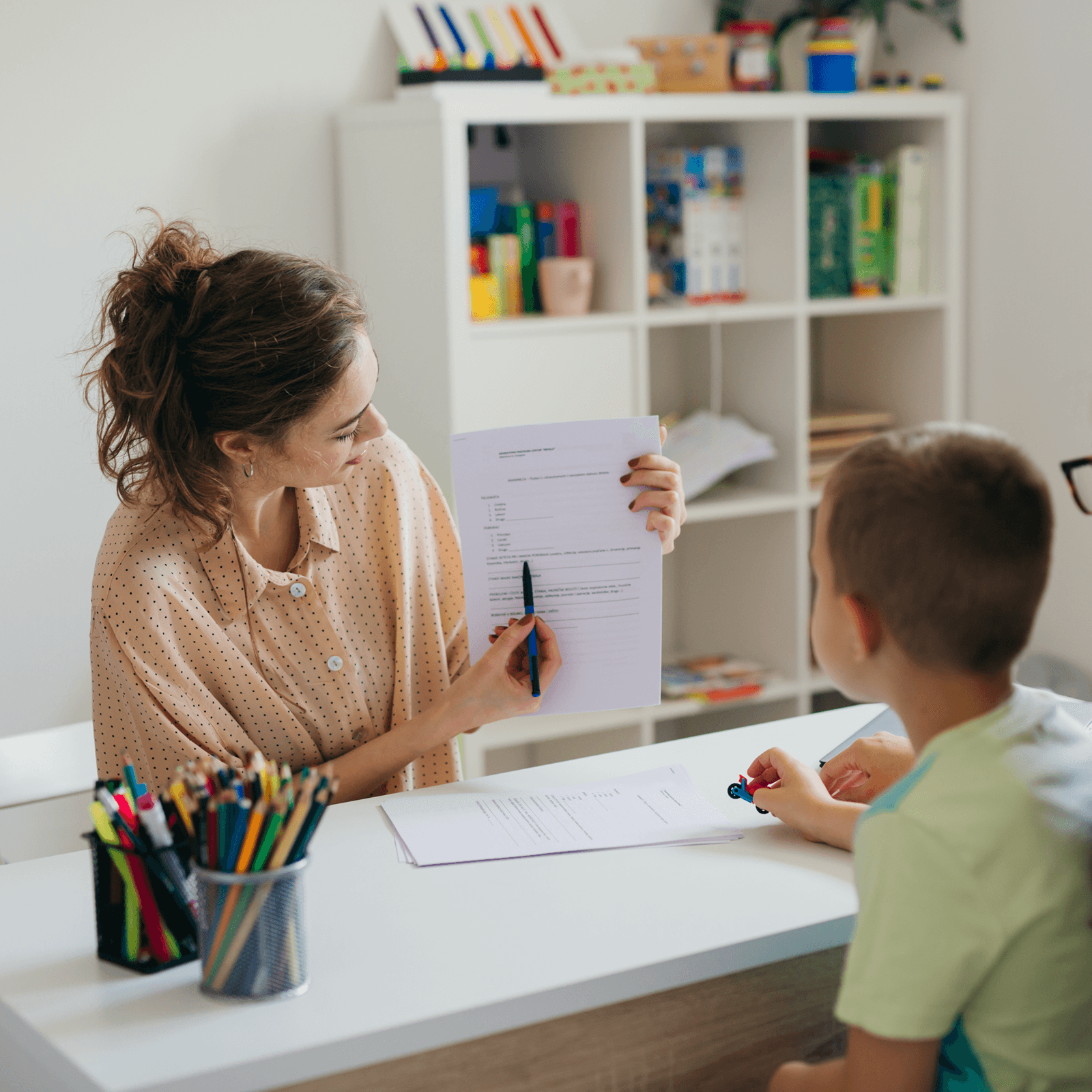 A teacher showing a child a graph