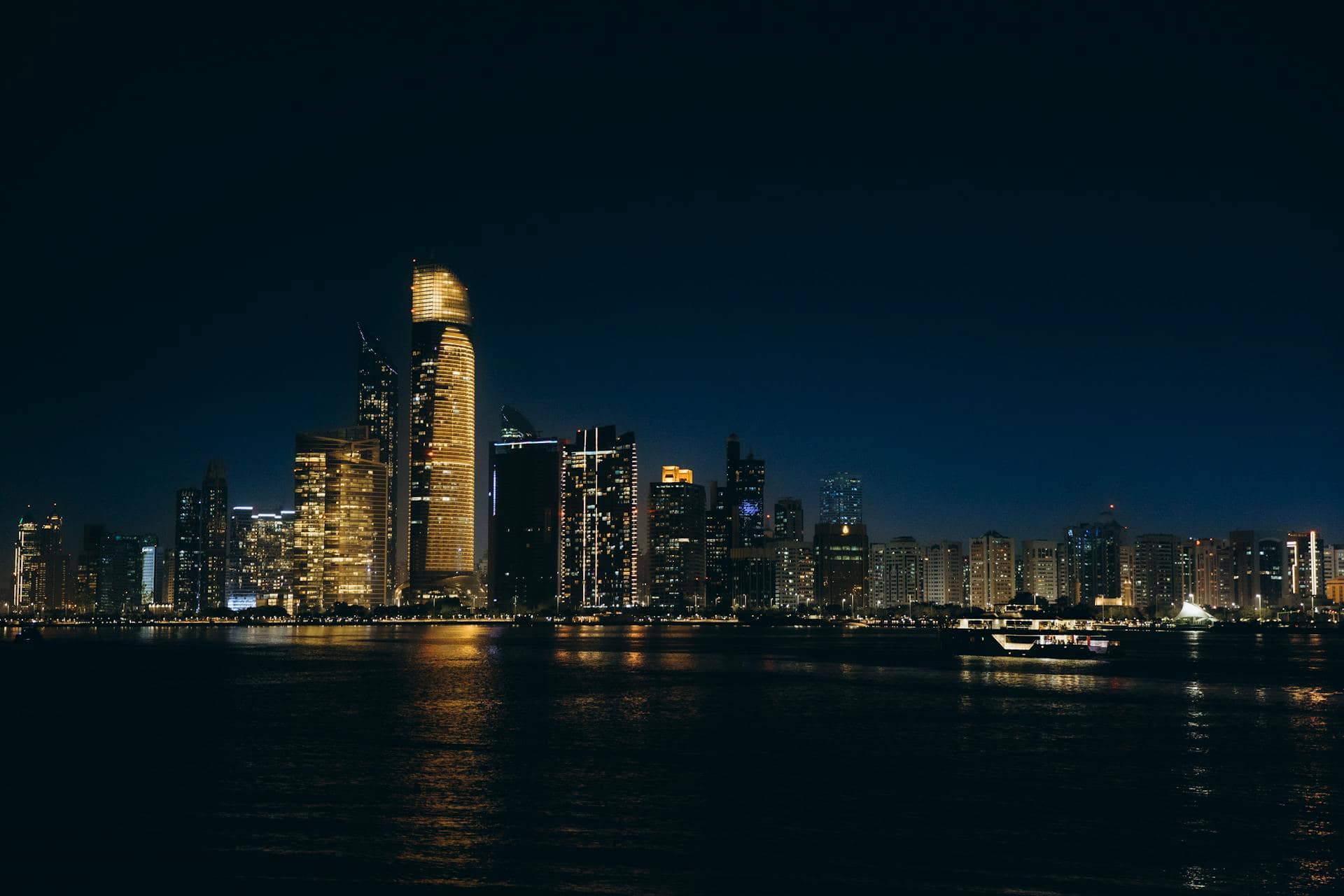 Website Development Abu Dhabi, a fountain in the foreground with the Abu Dhabi skyline behind it.