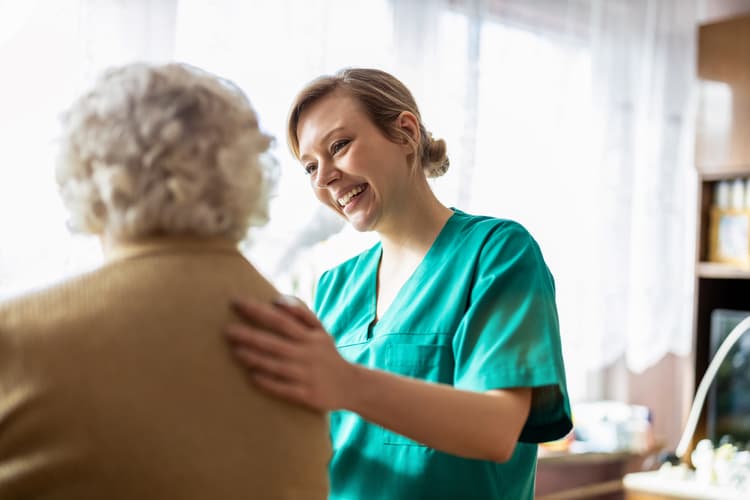 Healthcare assistant checking patient 