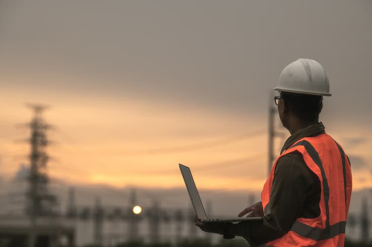 Utilities worker looking at power lines