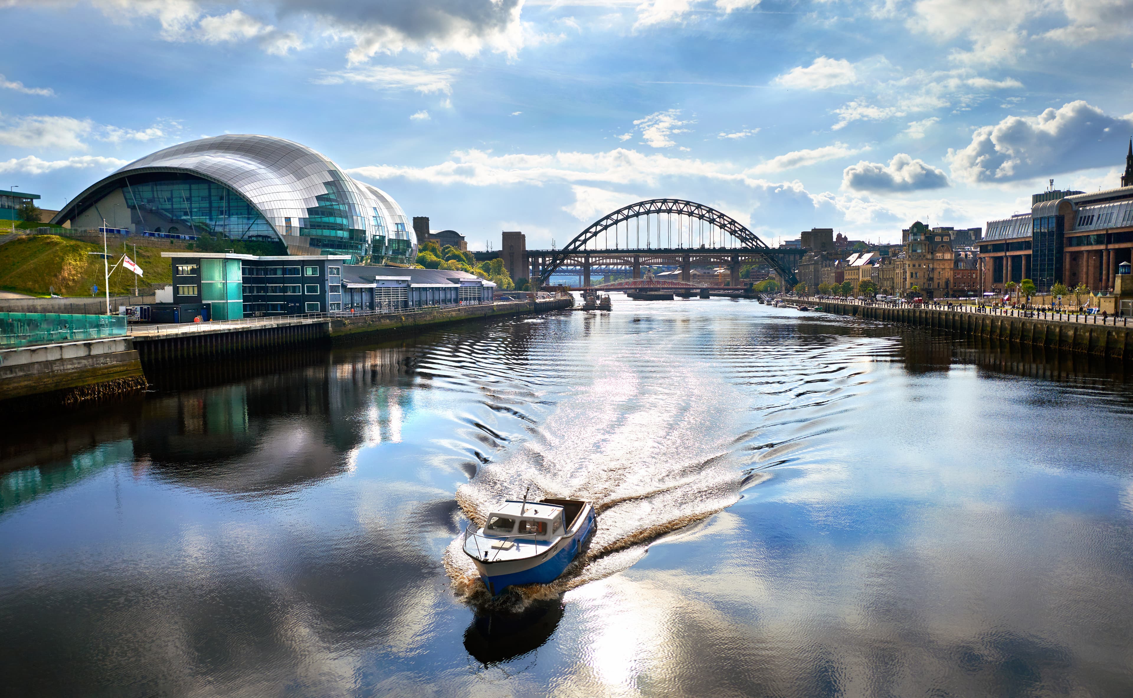 Image of a boat on the Tyne River passing Gateshead