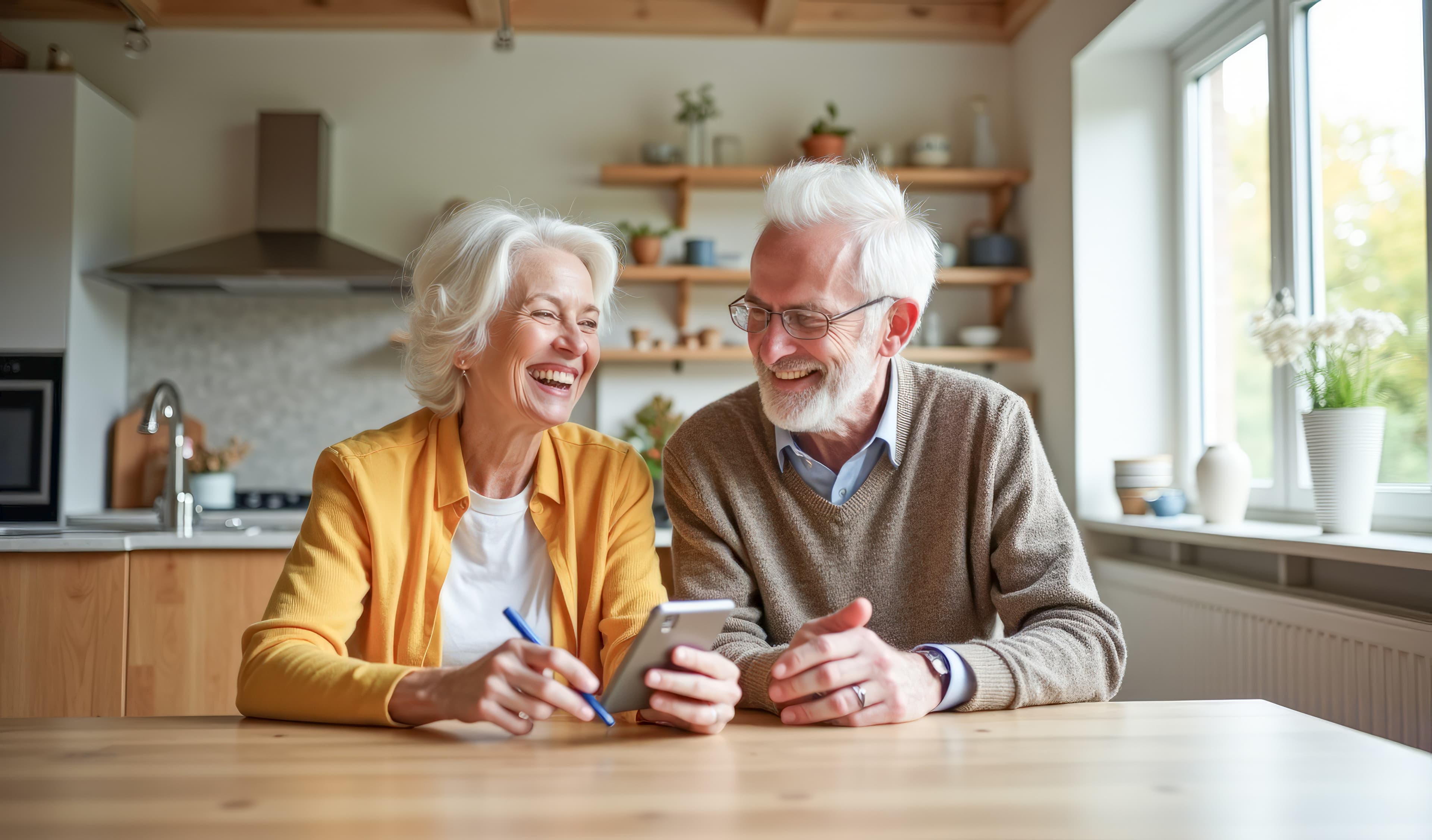 Two elderly people looking at a mobile phone
