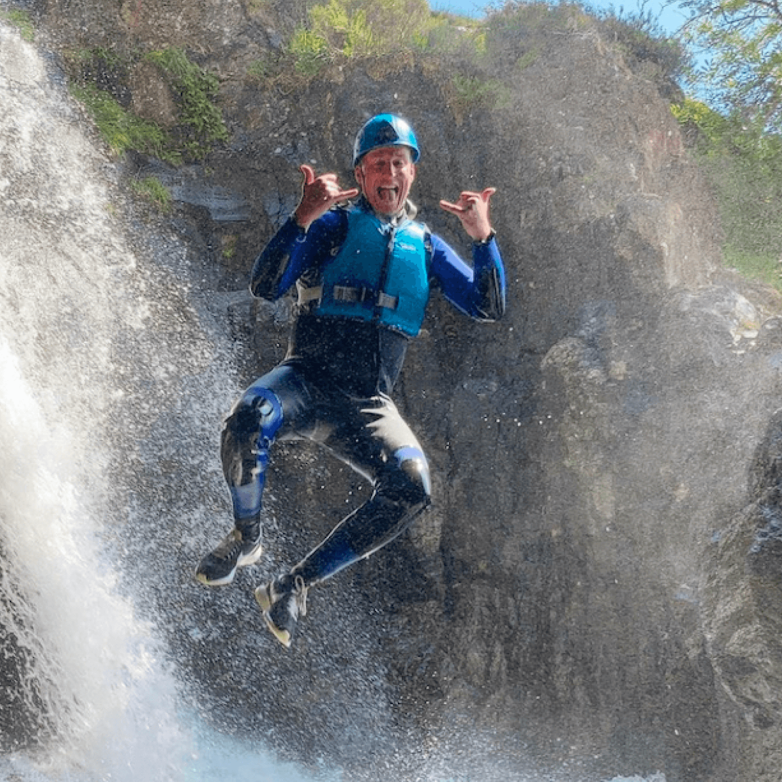 Crags adventure website a person jumping from a waterfall